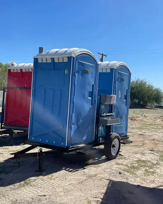 Porta potty on a towable trailer for moving between fields